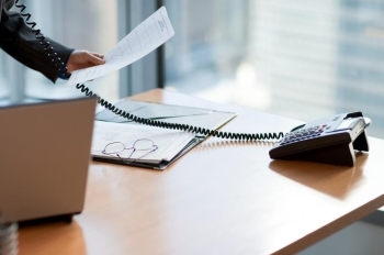 Desk with phone and laptop